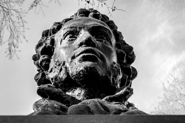 UFA, RUSSIA - 11 APRIL 2019: close-up bust of the Alexandr Sergeevich Pushkin against the sky,...