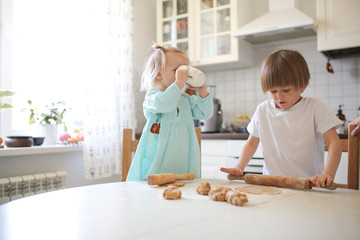 children make cookies in the kitchen on the table