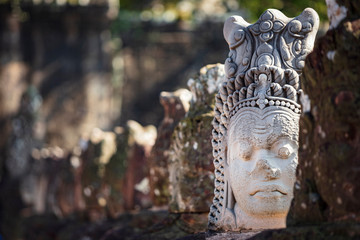 Reconstructed head sculptures, originally damaged by the Kyhmer Rouge, on the bridge leading to the south gate at Angkor Thom temple complex, Siem Reap, Cambodia