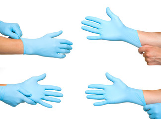 Doctor putting on protective blue gloves isolated on yellow background
