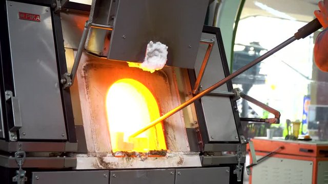 taking molten glass from furnace