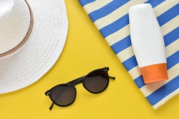 Summer vacation on the beach, sun protection set, hat, sunglasses, sunscreen lotion, beach blanket.