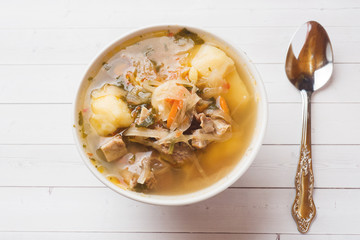 Soup of sauerkraut, meat stock in the dish.