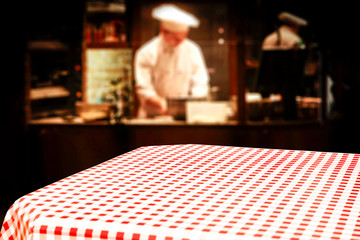 Table background of free space in restaurant interior and cook chef. 