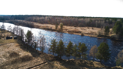 Obraz premium Amazing aerial shot of beautiful dark river shore. Forest background.