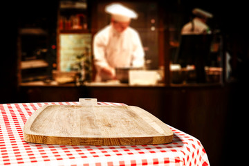 Table background of free space in restaurant interior and cook chef. 