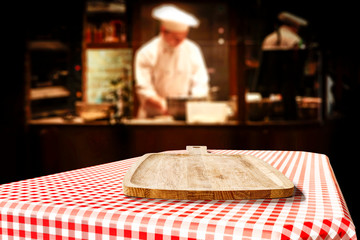 Table background of free space in restaurant interior and cook chef. 