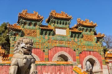 Dragon lion guard in front of Gate with three arches in park of Putuo Zongcheng temple in China...