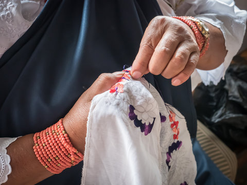 Indigenous woman doing traditional embroidery, Otavalo, Ecuador