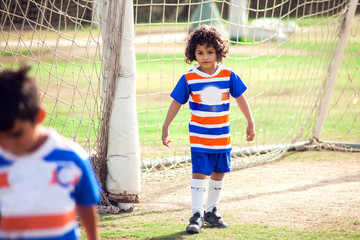 Little boy plays football outdoor. Children and lifestyle concept