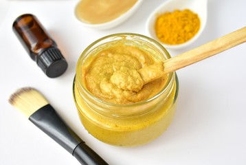 Acne face mask with turmeric powder, honey, tea tree oil, close up view.