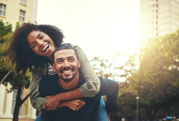 Man giving piggyback ride to woman