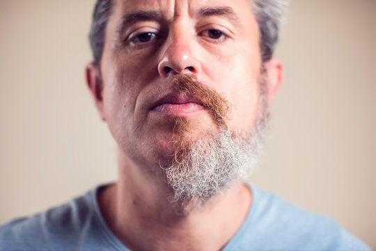 A portrait of man with half beard and hair
