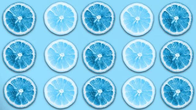 Abstract blue color animation of sliced lemon and grapefruit on pastel b