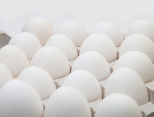 Close-up white chicken eggs. Concept for a background image about farming and selling poultry products.
