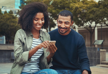 Man looking at his girlfriend using mobile phone