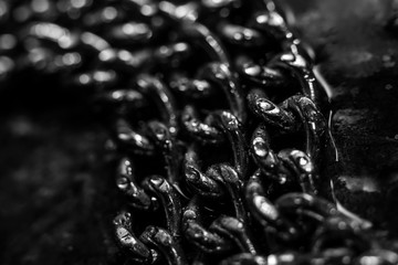 Shiny metal chains on stone background