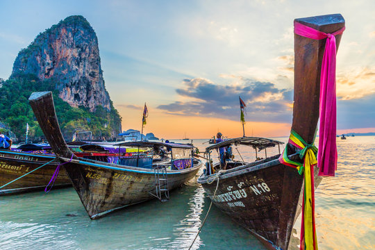 Long tail boats at sunset on Railay beach in Railay, Ao Nang, Krabi Province