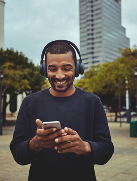 Young Man Watching Video Using Mobile Phone