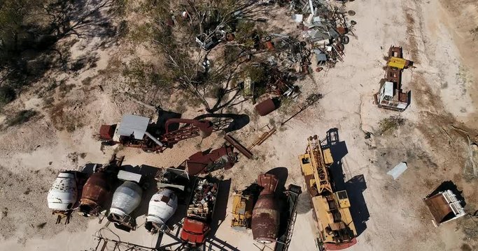 Abandoned rusty scrap metal yard with old heritage machinery, cars, equipment near Lightning Ridge opal mining town in Australian outback.