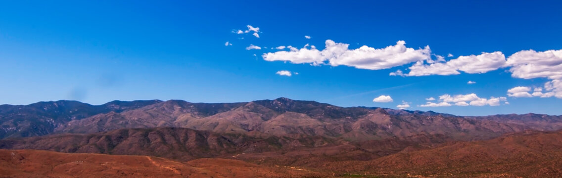 A spring Arizona landscape with white clouds and bright blue skies