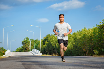 Young Man jogger athlete training and doing workout outdoors on street  road