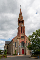 Fototapeta na wymiar The church in Saint-Lyphard on a cloudy day in summer