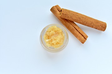 Lip scrub with cinnamon in small jar, homemade natural cosmetic.