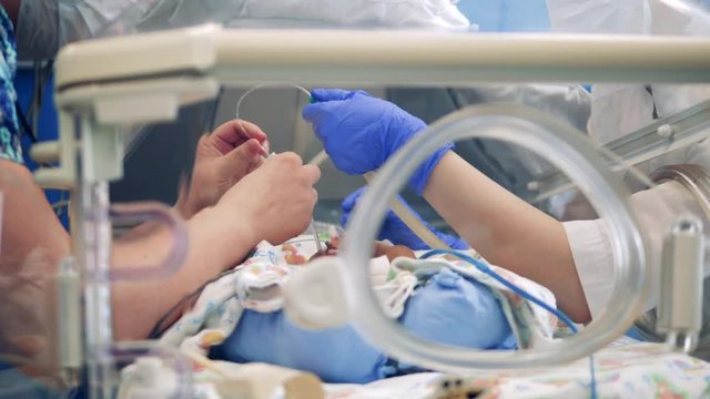 Doctors are carrying out a medical procedure on a baby