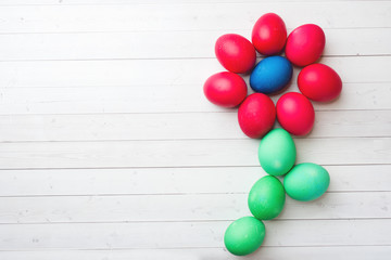 Colorful Easter eggs on white table. Copy space.