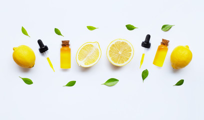 Essential oil with lemon on white.