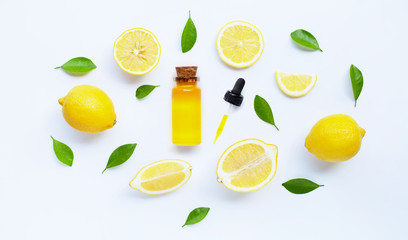 Essential oil with lemon on white.
