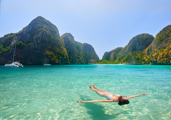 Happy young woman enjoying swimming in refreshing sea water Phi Phi Island, Thailand