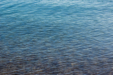 Obraz premium soft blue transparent shallow water near sea shoreline background surface