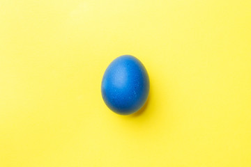 Colorful Easter eggs on yellow background. Copy space.
