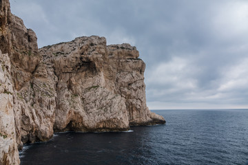 Capo Caccia, a rocky outcrop set in a protected ecosystem near the town of Alghero, Sardinia, Italy. featuring. Scenic hiking routes, diving sites & caverns with archaeological remains