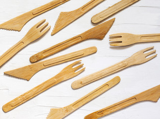 Collection of Eco friendly bamboo cutlery on white background, flat lay, top view.