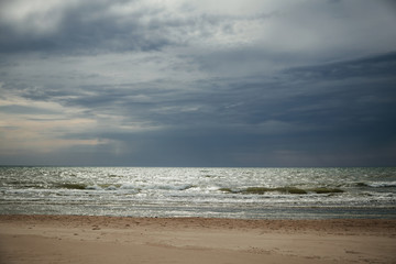 Dramatic beach with dark clouds before a storm. 