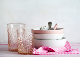 Empty pink and white bowls and kitchen utensils