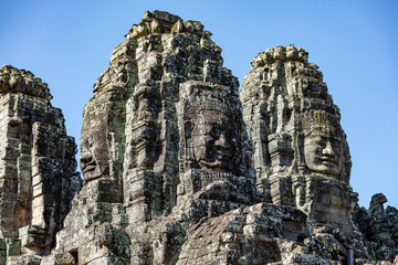 Beautiful face sculptures at the famous Bayon temple in the Angkor Thom temple complex, Siem Reap,...