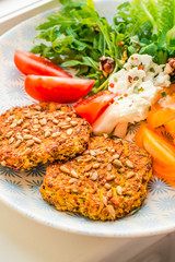 Baked vegan burgers with beans and seeds, vegetables and herbs. Healthy lifestyle and balanced food concept.