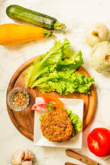 Baked vegan burgers with beans and seeds, vegetables and herbs. Healthy lifestyle and balanced food concept. Top view.