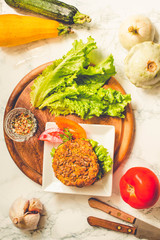 Baked vegan burgers with beans and seeds, vegetables and herbs. Healthy lifestyle and balanced food concept. Top view.Tone.