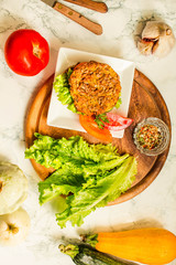 Baked vegan burgers with beans and seeds, vegetables and greens. Vegan and vegetarian food concept. Top view.