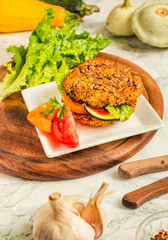 Baked vegan burgers with beans and seeds, vegetables and herbs. Healthy lifestyle and balanced food concept.