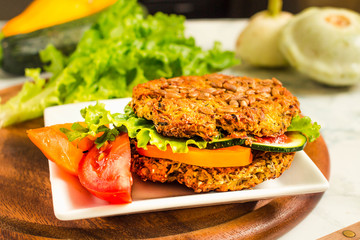 Baked vegan burgers with beans and seeds, vegetables and herbs. Healthy lifestyle and balanced food concept.