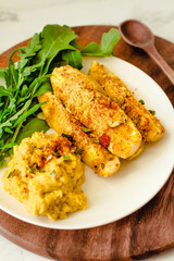 Baked Garlic Parmesan Zucchini sticks, crunchy and crispy.  Served with hummus sauce.Close-up.