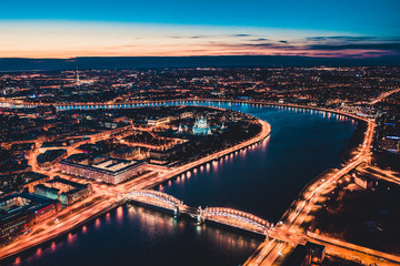 Obraz premium Beautiful evening scene with the famous Tower Bridge of St.Petersburg illuminated and reflected in Neva river
