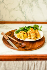 Baked zucchini sticks in crispy batter with hummus and arugula. Quick and Easy Vegetable Side...
