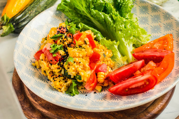 Vegetable risotto with black sesame, tomatoes and greens.Healthy lifestyle and balanced food concept.